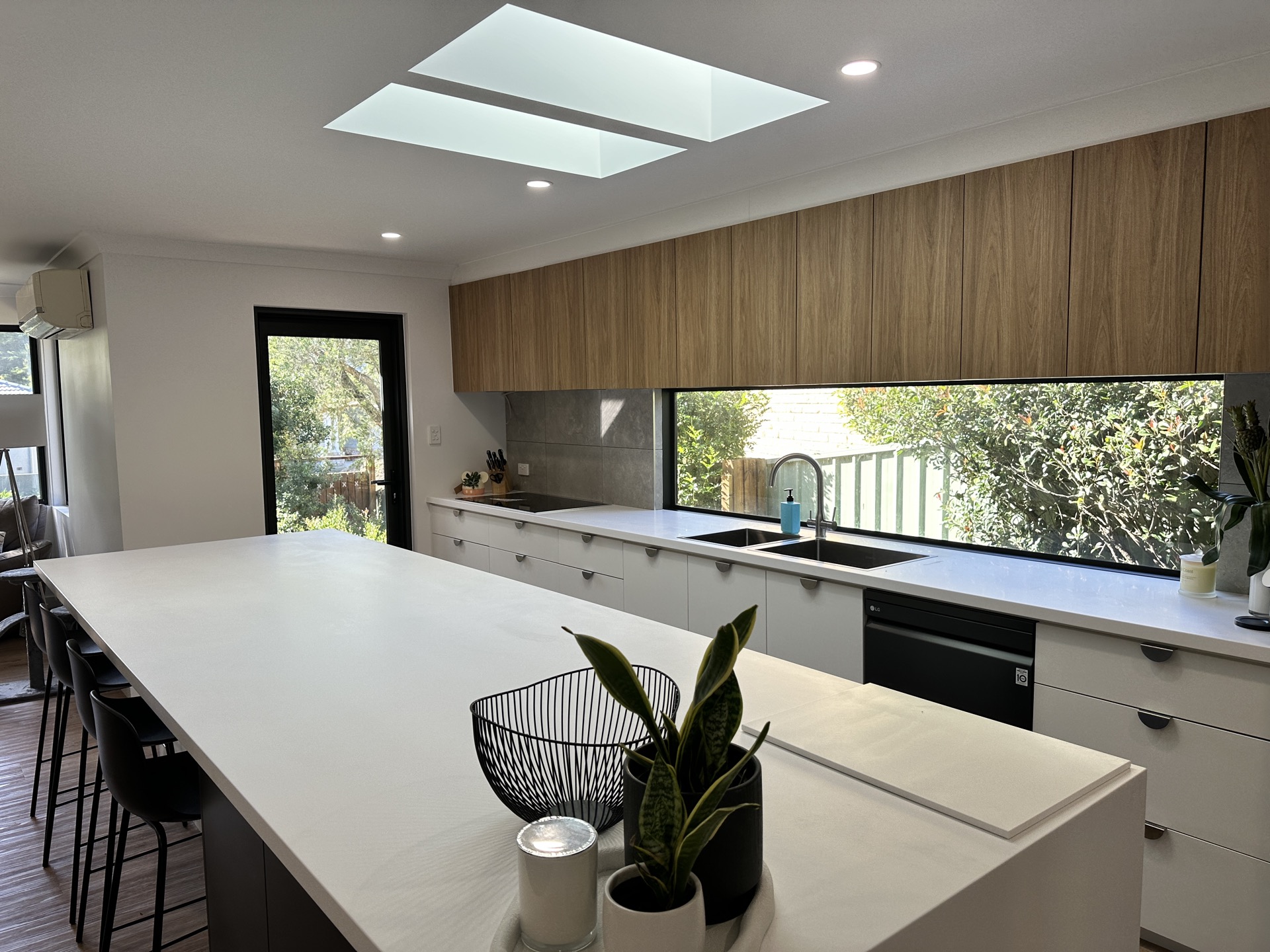 Open-plan kitchen and living with timber cabinetry and island bench by 3BC